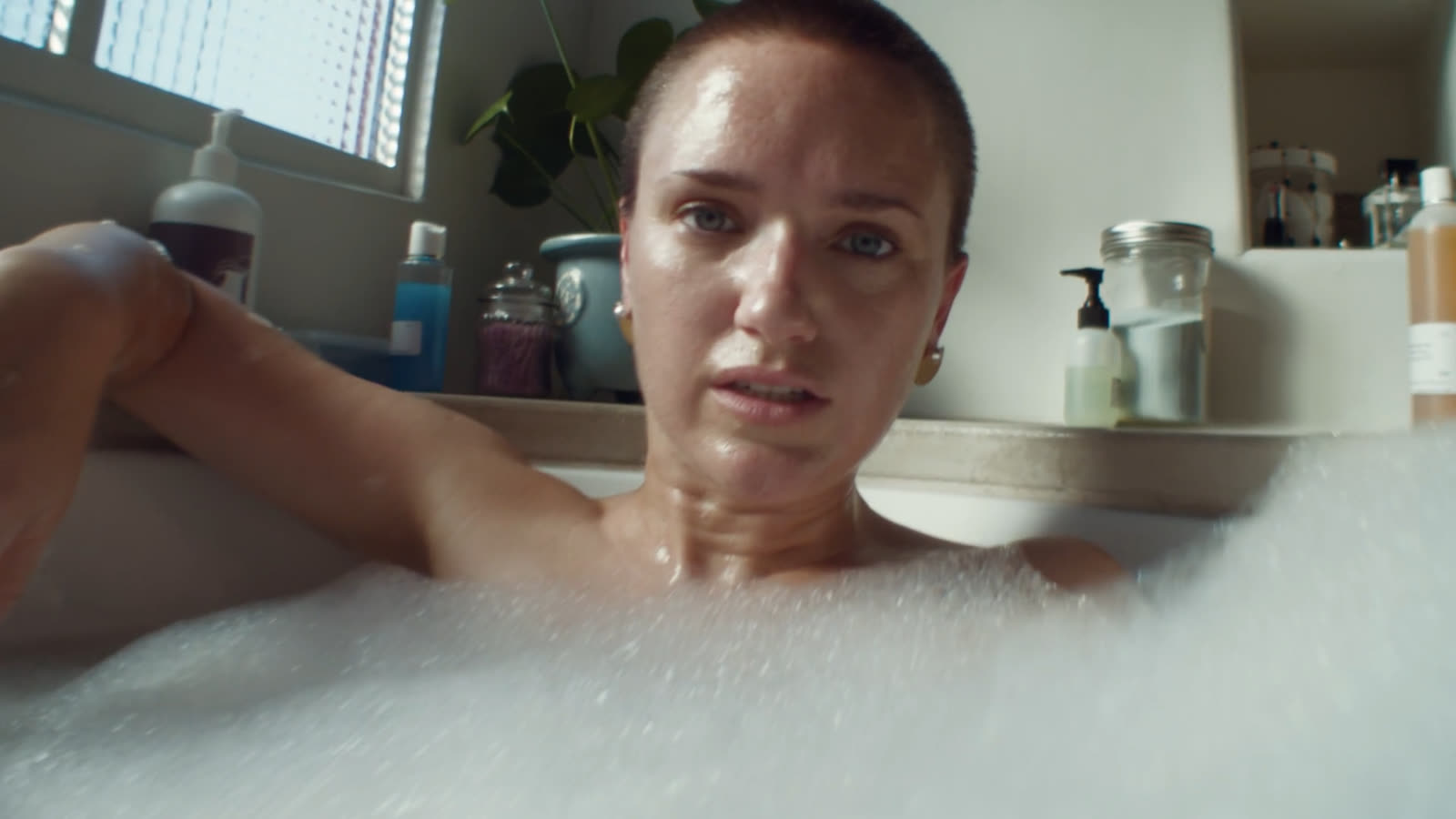 Woman in a bath looks into the lens