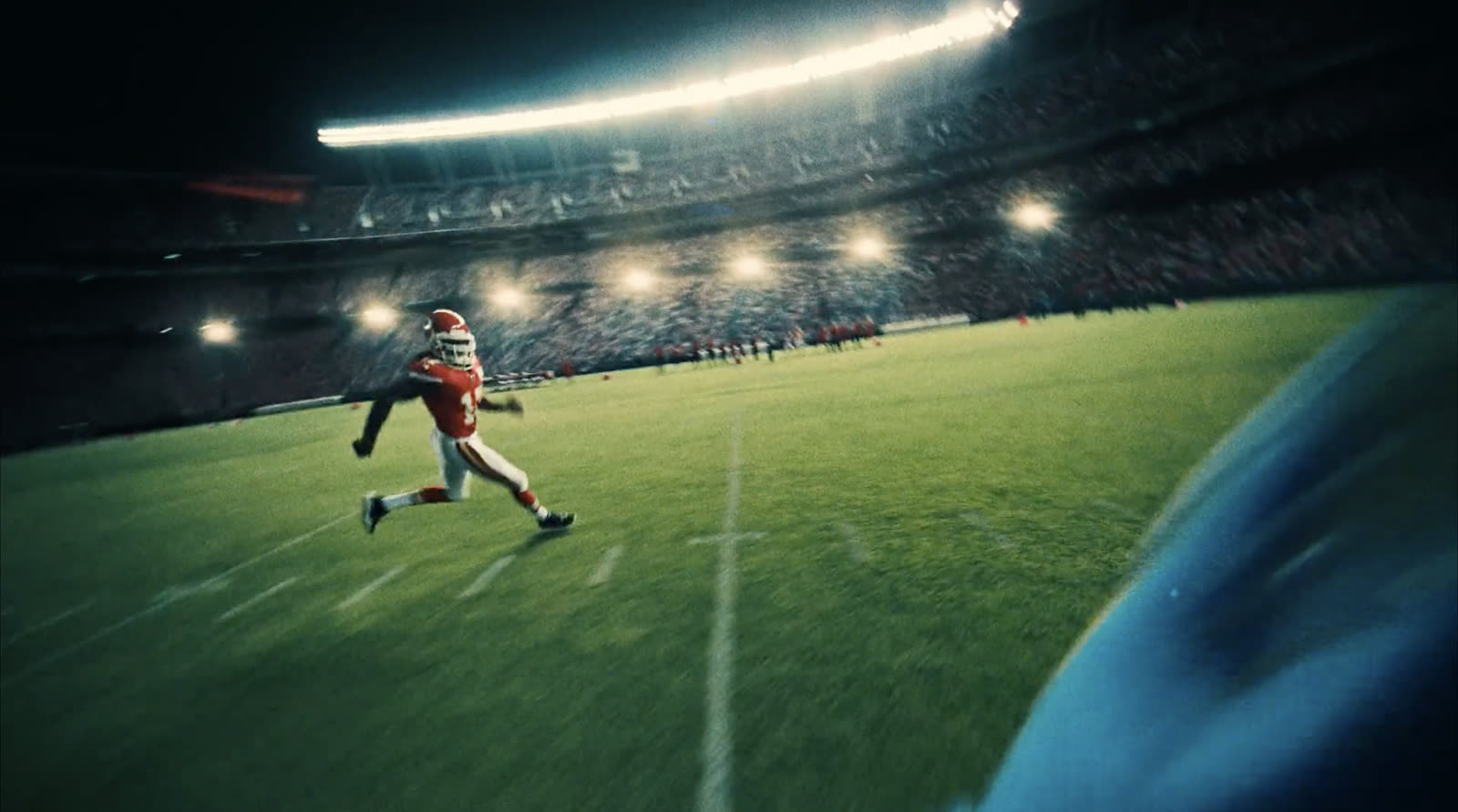Wide POV from a player's shoulder under stadium lights
